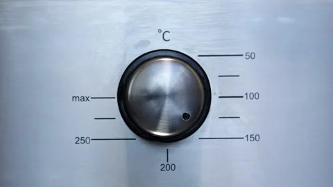 Man Turns Down The Oven Temperature From 150 Degrees Celsius Video stock 250332148