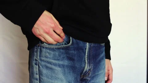 Man turns the empty pockets of his jeans. No money Stock Footage 49066490