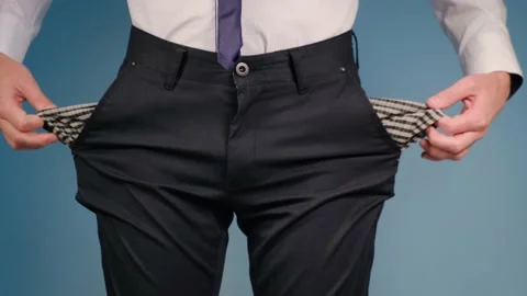 A man turns empty pockets of his trousers Stock Footage 162495388