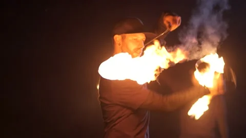 Man turns hot fireballs in front of face. Dangerous fire tricks. Play with fire 스톡 동영상 140292820