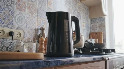 Man turns the kettle on Stock Footage 163990682