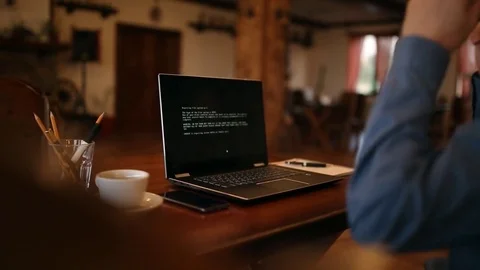 Man turns on a laptop waits for loading computer and finds out it is infected by Stock Footage 84858458
