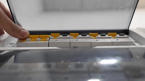 Man turns on the light in the electrical panel close-up. Stock Footage 261028040