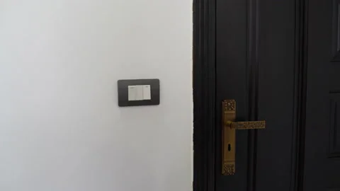 A man turns off the light opens the door and leaves the room Video stock 101659349
