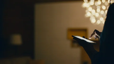 Man Turns On The Light Through The Smartphone Stock Footage 127946941