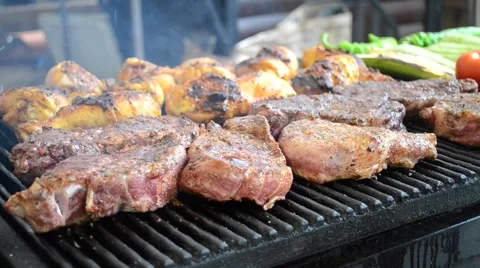 Man turns meat steaks Stock Footage 56139029