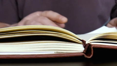 Man turns over the book Stock Footage 79411036