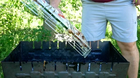 Man turns over the roasted assorted vegetables on the barbecue. Tomatoes Stock Footage 201925885