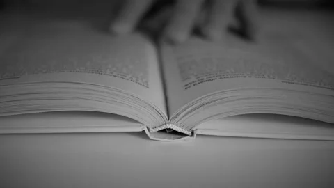 Man turns a page in a book Stock Footage 142607063
