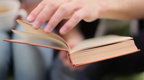 Man turns pages of a book Stock Footage 60583565