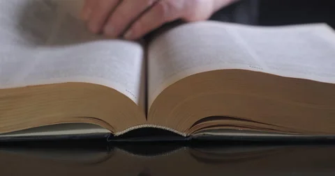 The man turns the pages of the textbook Stock Footage 166317208