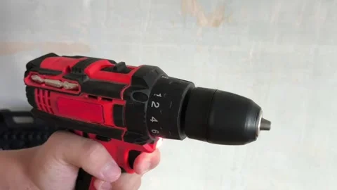 A man turns on a power drill without a drill. Cordless power tools. Stock Footage 322894017