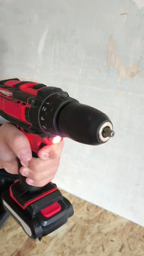 A man turns on a power drill without a drill. Cordless power tools. Stock Footage 322894151