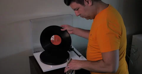 Man turns off turntable and puts vinyl away. Stock Footage 140265201