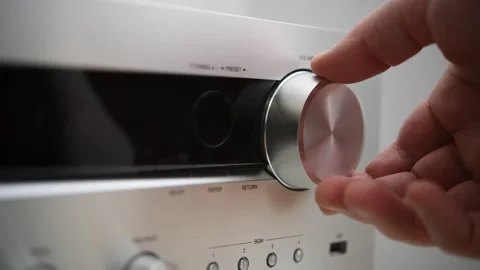 A man turns up the volume on an audio device's control panel. Stock Footage 298037333