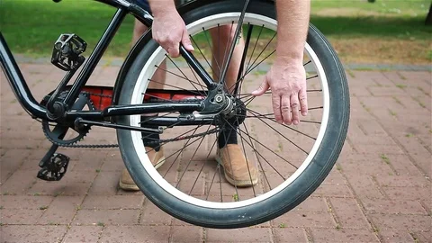 Man turns the wheel of a bicycle Stock Footage 92459612