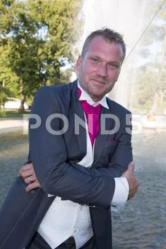 Man With Tuxedo And Pink Tie, Crossed Arms