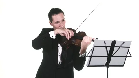 Man in a tuxedo performs a slow composition on a classical violin. Isolated Stock Footage 134495618