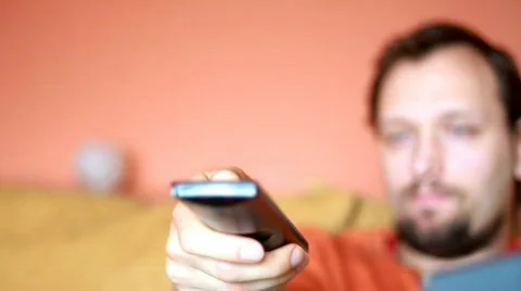 Man with tv remote control, dolly shot Stock-Footage 685698