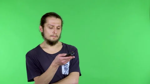 A man with a TV remote control in his hand, who changes channels, stops at Video stock 150739005