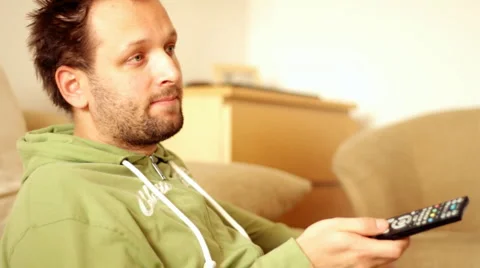 Man with a tv remote control, steadicam shot Stock Footage 1829455