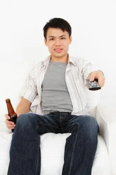 Man with tv remote Stock Photos