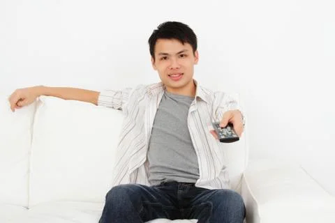 Man with tv remote Stock Photos