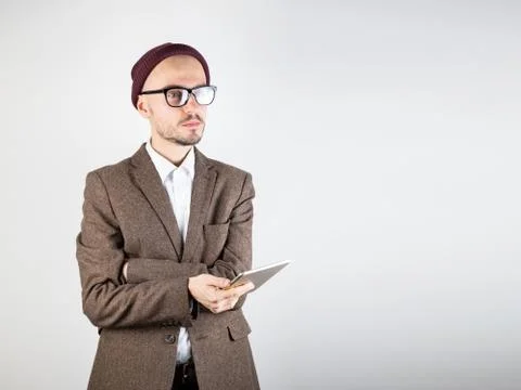 Man in tweed jacket with a tablet computer. Stock Photos