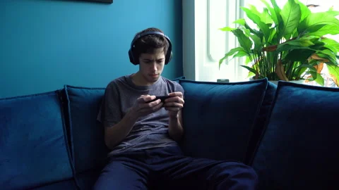 Man in Twenties losing his mind on a Mobile Videogame Stock Footage 274232168