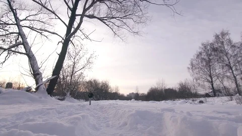 A man in the twilight at sunset runs through deep snow Stock Footage 85085211