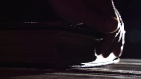 The man in the twilight, turning the pages of an old book Stock-Footage 89103028
