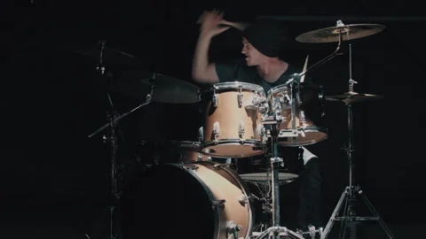 Man twirling drumstick while playing in dark room Stock Footage 275102658