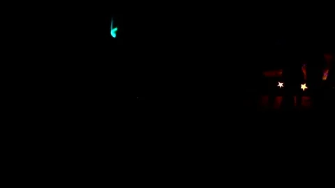 Man twirls a glowing spinner in the dark at the festival Video stock 144041740