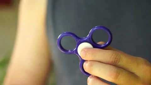 Man is twisting the blue spinner. Slow motion, close-up hands Stock Footage 78206768