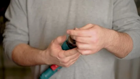 Man twisting drill bit into drill, close up. Preparation for drilling walls to Stock Footage 269326665