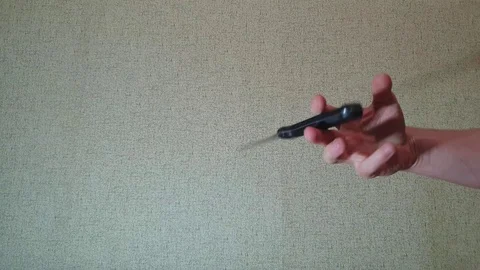 The man is twisting a knife in his hand slow motion.Knife in his hand. Stock Footage 107833293