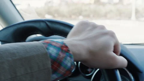 Man twisting steering wheel of car during driving, day road Stock Footage 106016264