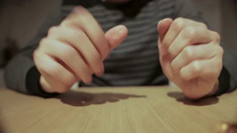 A man twists a candy wrapper in his hands and throws it out, close-up Stock Footage 165441638