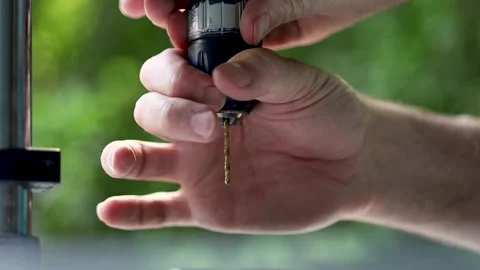 A man twists the head of the drill and clamps the drill bit Video stock 244936035