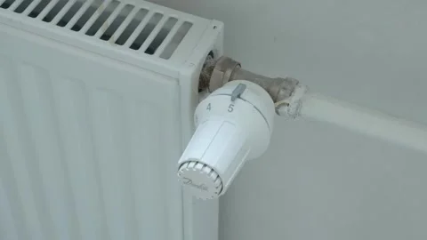 A man twists the heating with his hand Stock Footage 132495564
