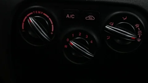 Man twists the knobs of climate control in the car. Video stock 73615271