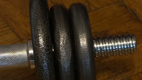 Man twists spin lock collar on the dumbbell. Stock Footage 70352119