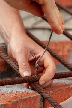 Man twists the wire in construction Stock Photos