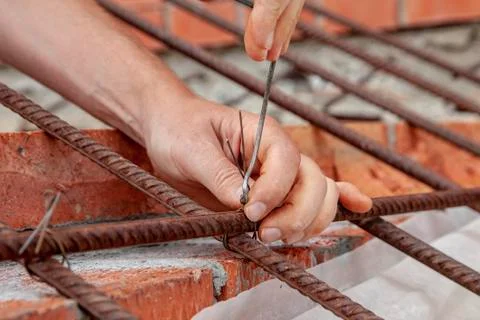 Man twists the wire in construction Stock Photos