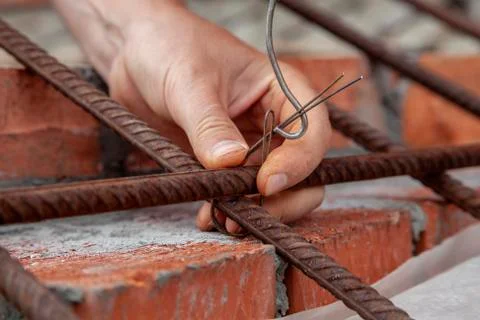Man twists the wire in construction Stock Photos