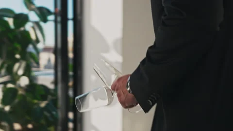 Man with two champagne glasses goes to rooftop patio area for a romantic dinner Stock Footage 201469166