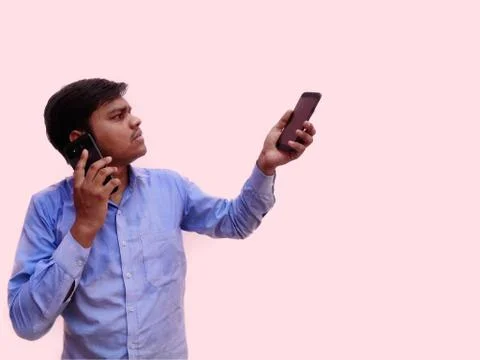 Man with two mobile one for calling other for business, pink background. Stock Photos
