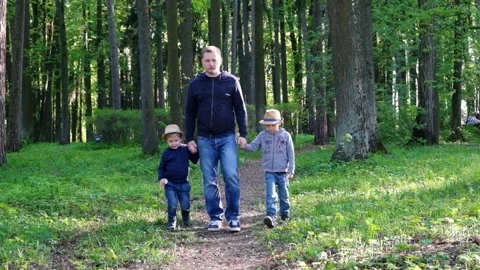 Man with two sons walking in the park 動画素材 89659218