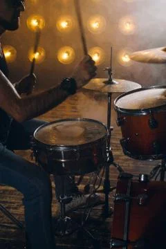 Man with two sticks playing at the studio Stock Photos