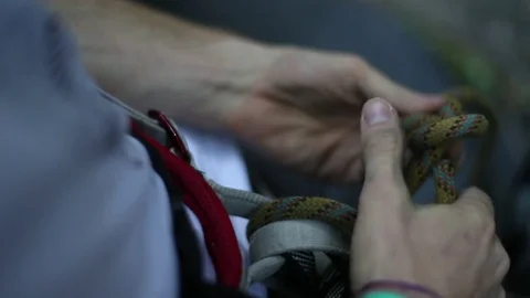 Man tying the eight knot to harnesses. Preparation for rock climbing.   스톡 동영상 73236089